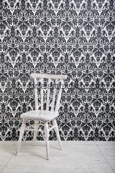 white wooden chair against vintage wallpaper
