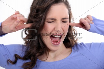 Woman with her fingers in her ears
