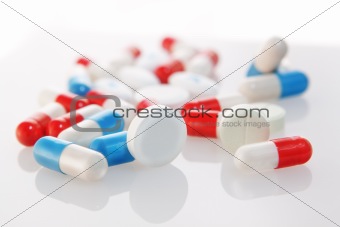 diverse group of tablets and capsules.