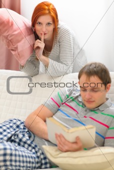Red hair girl want to start pillow fight with boyfriend