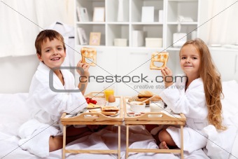 Breakfast in bed with happy kids