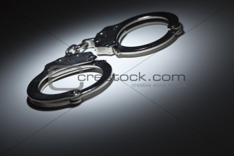 Abstract Pair of Handcuffs Under Spot Light With Room For Your Own Text.