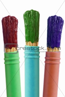 three paintbrushes with color paint