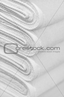 Stack of new white towels close-up - background
