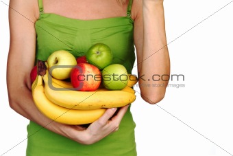 woman holds a pile of fruit