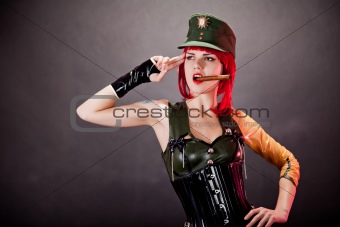 Young woman dressed in military style latex 