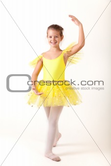 Smiling little ballerina exercising 