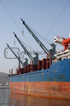 three cargo ship cranes
