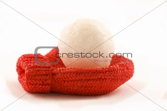 A red mitten holding a snowball