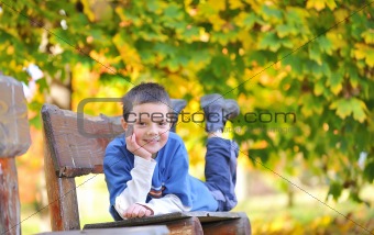 boy laying down on a bench