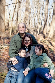 Happy Family Portrait in the Woods