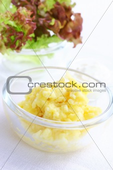 Mashed potatoes in bowl with salad