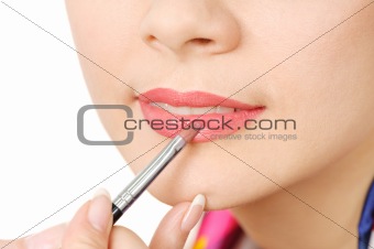 applying liquid glossy lipstick 