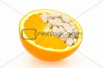 Close up of orange and pills isolated - vitamin concept