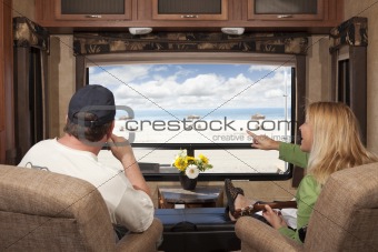 Young Couple Enjoying the Beach View From Their 5th Wheel RV.
