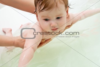 Infant holding with woman hands preparing to dive