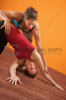 Yoga Trainer Assisting Student