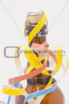 Studio shot of cider bottle with party streamers