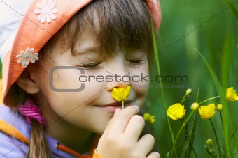 girl smelling a flower