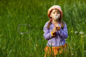 girl with a dandelion in the hands of