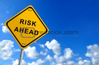 risk ahead traffic sign on bluesky