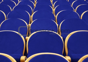 Empty concert hall with blue chairs