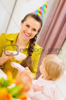 Mother drinking tea on babies birthday party