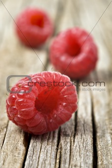 Fresh healthy organic raspberry on wooden background