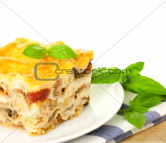 Delicious Italian Lasagna / with fresh basil / white background 