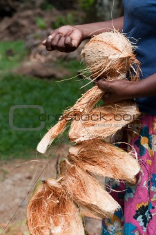 Coconut in female hands with removed shell