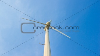 white wind turbine on blue sky