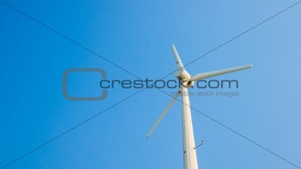 white wind turbine on blue sky