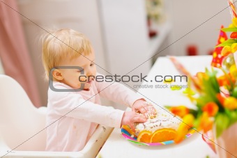 Eat smeared baby touched birthday cake by hands