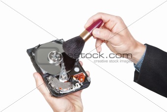 Cleaning open hard disk with brush. On a white background.