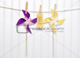 Summer Sale Concept Pinwheels with Sale Sign on Clothesline.