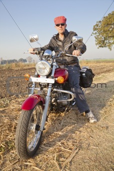 full length portrait of european biker in hinterland