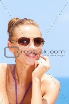 Pretty woman at the beach with sunglasses