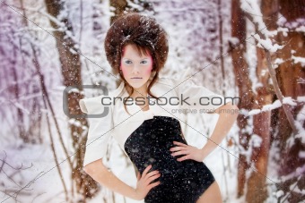 Fashion make-up girl in a fairy winter forest