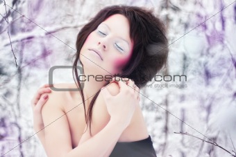 girl with beauty make-up in a fantasy winter forest