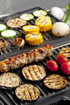 meat skewer and vegetables on electric grill