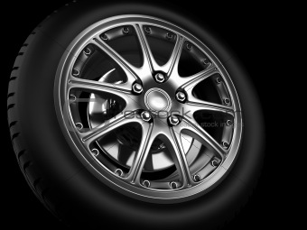 Background closeup automotive wheel with alloy metallic rim