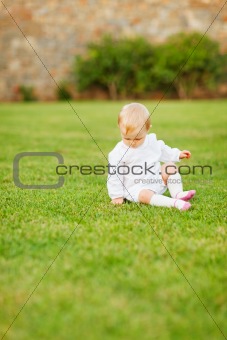 Baby sitting on grass