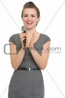 Woman reporter with microphone applauding isolated