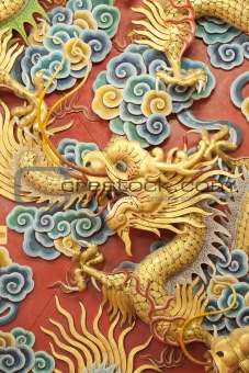 Statue of golden dragon on the wall 