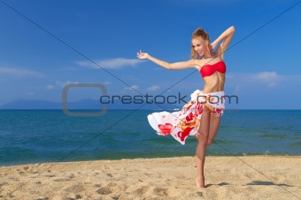 Adorable woman standing at the tropical beach
