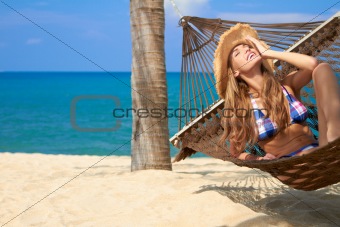 Attractive woman relaxing in a hammock