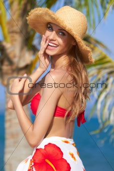 Happy young woman posing in straw hat