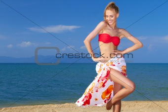 Adorable woman standing at the tropical beach