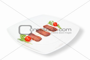 The composition of smoked tuna on a plate. On a white background
