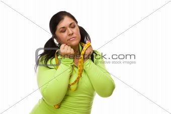 Attractive Frustrated Hispanic Woman with Tape Measure Against a White Background.